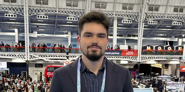 Andrii standing in a large exhibition hall