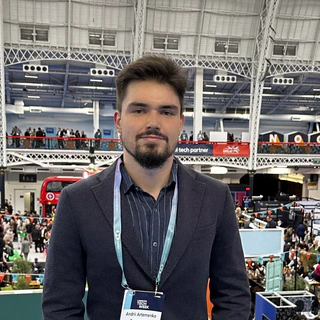 Andrii standing in a large exhibition hall